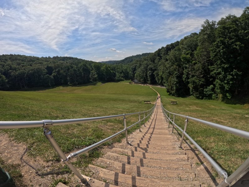 Steps on Dam. Follow the trail to the left.